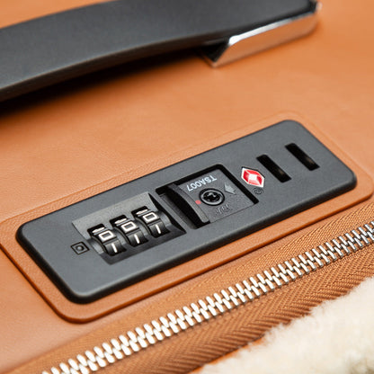Close-up of a suitcase with a combination lock and TSA lock feature.