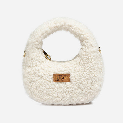 White shearling handbag with UGG logo on a white background
