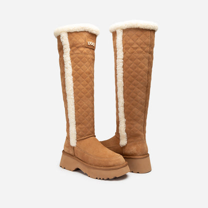 Pair of tan knee-high UGG boots with white fur lining on a light gray background