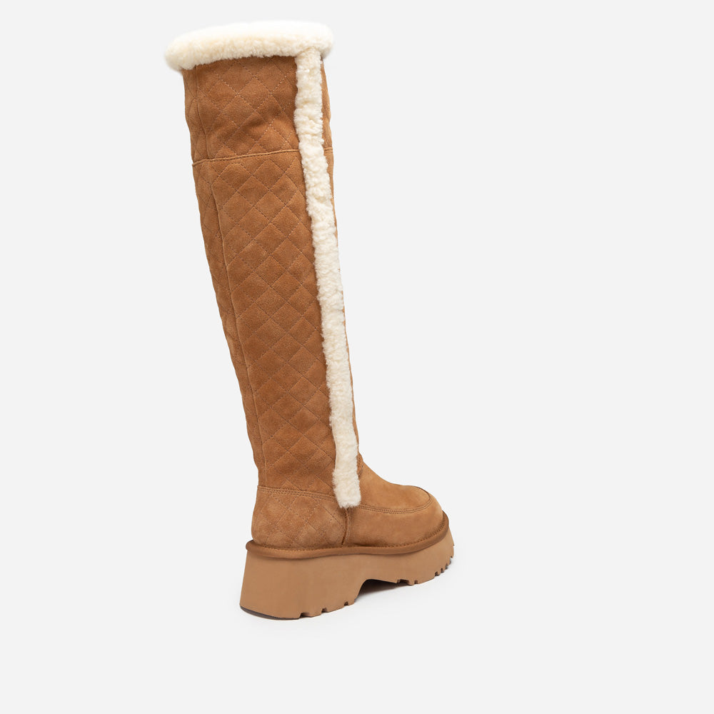 Brown knee-high UGG boot with white fur lining on a white background