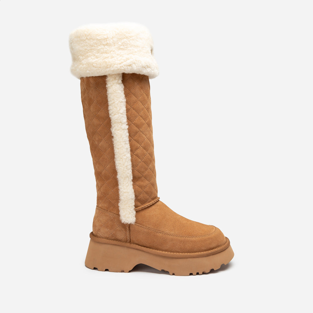 Tan knee-high UGG boot with white fur lining on a light gray background