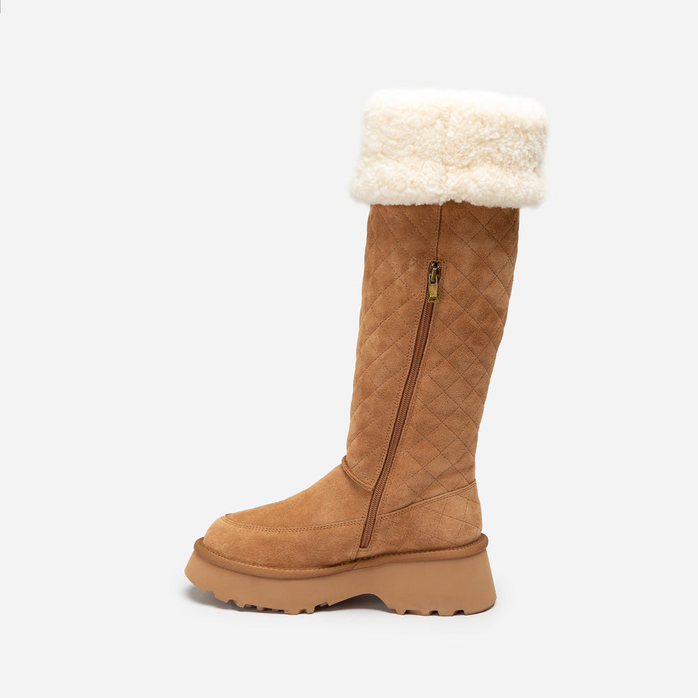 Tan quilted knee-high UGG boot with white fur lining on a white background