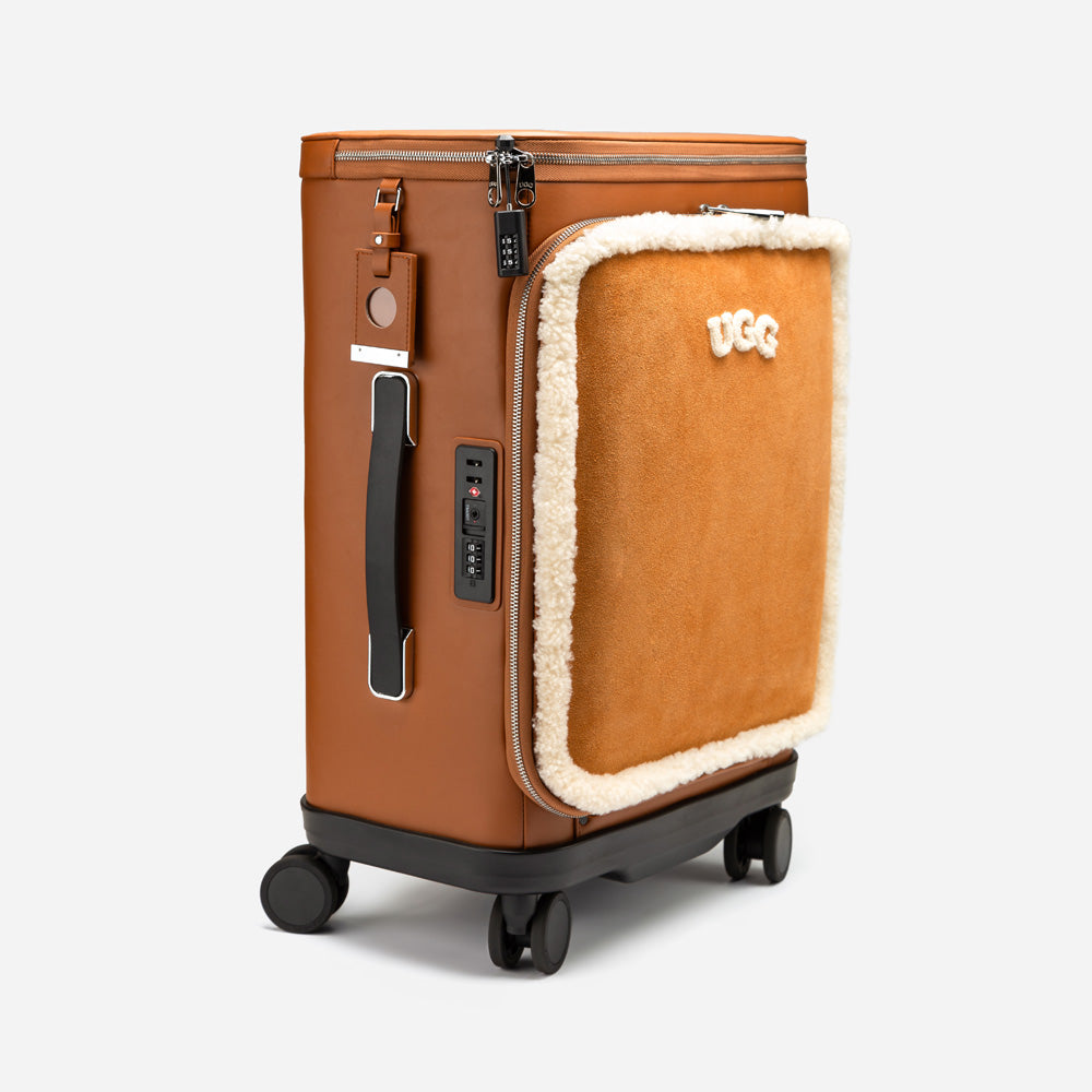Brown suitcase with UGG logo on a light gray background
