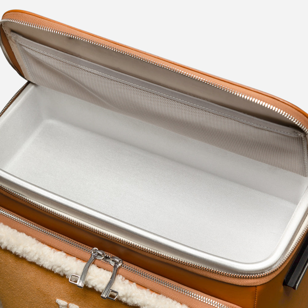 Open suitcase with interior lining and zipper detail on a white background
